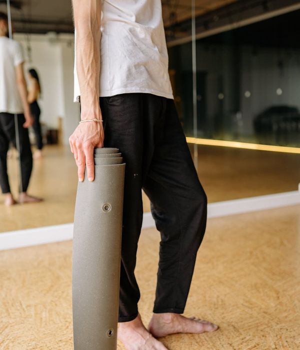 Man holding a difficult balance pose, showing core strength and concentration.